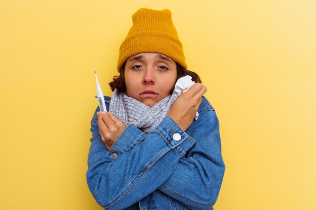 Photo young mixed race woman with a cold on yellow wall