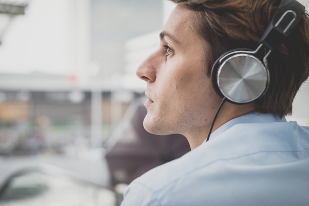 young model hansome blonde man with headphones