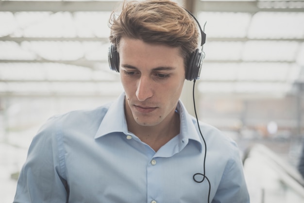 young model hansome blonde man with headphones