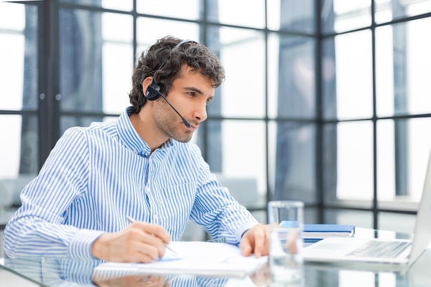 Young modern business man analyzing data using computer while working in the office