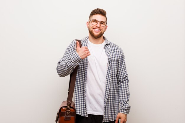 Young modern business man smiling and raising thumb up