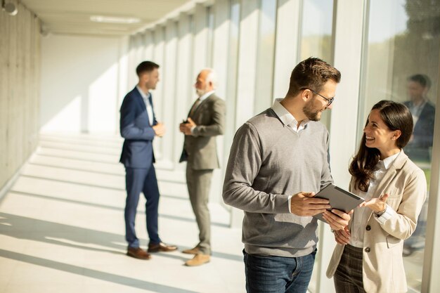 Young modern business people using digital tablet in the office