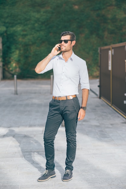 Young modern businessman posing