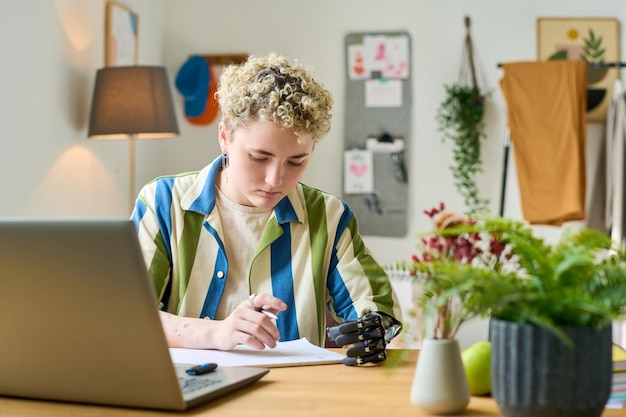 Young modern businesswoman or female employee working in home office