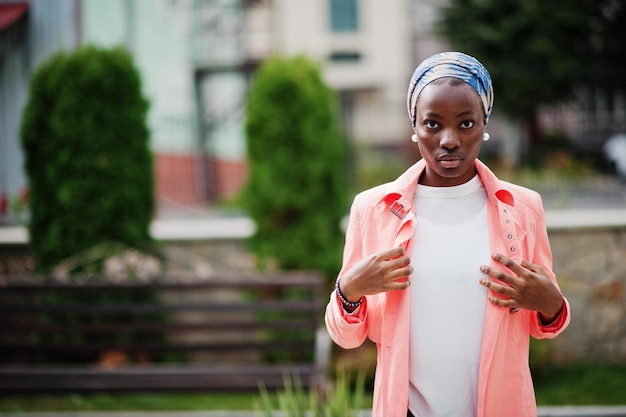 Young modern fashionable attractive tall and slim african muslim woman in hijab or turban head scarf posed