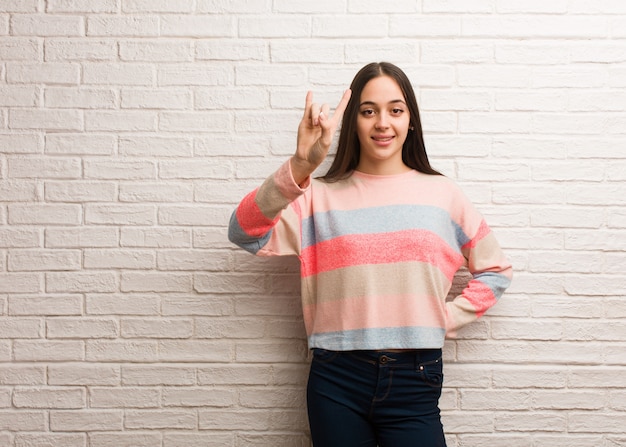 Young modern woman doing a rock gesture