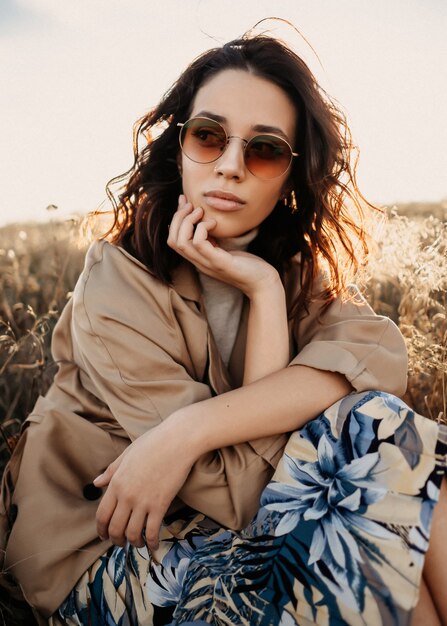 Young modern woman outdoors, wearing sunglasses