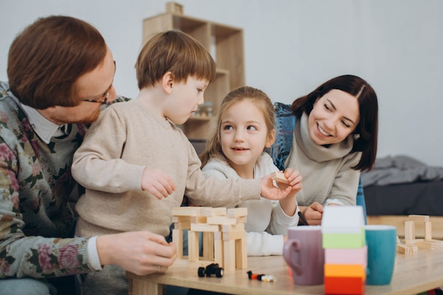 Young mom and dad play educational games with children