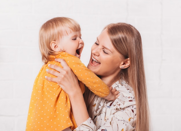 Young mom and her little daughter have fun together