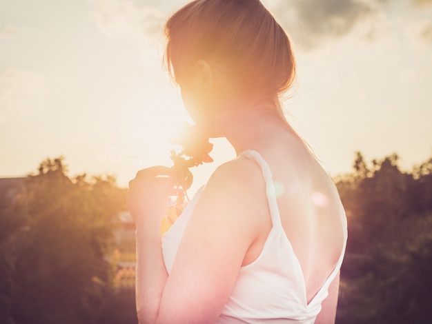 Young mom in a stylish, white dress