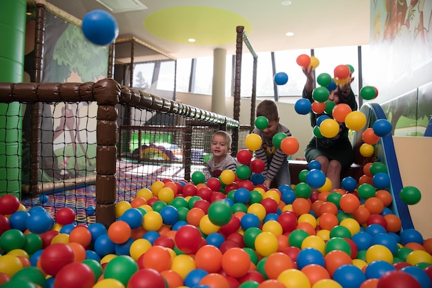 Young mom with her kids in a childrens playroom