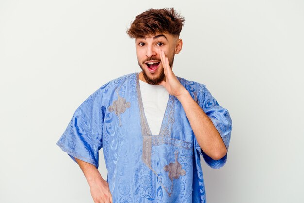 Young Moroccan man isolated on white shouting excited to front.