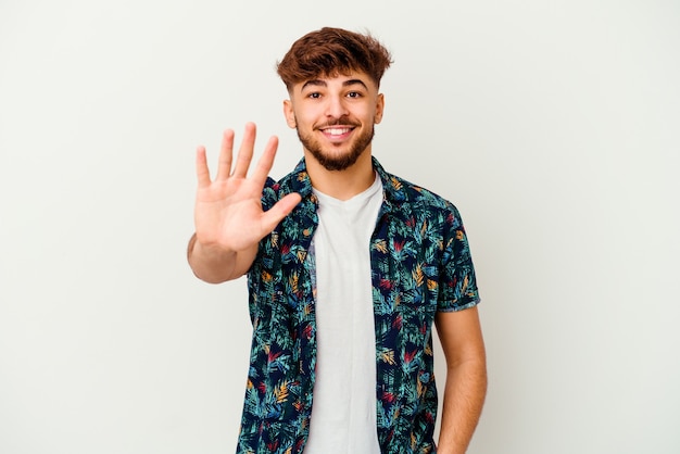 Young Moroccan man isolated on white smiling cheerful showing number five with fingers.