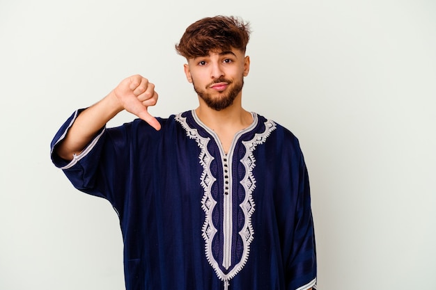 Young Moroccan man   showing a dislike gesture, thumbs down. Disagreement concept.