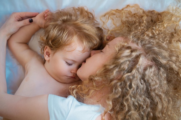 Young mother and baby child sleeping together dreams and kids sleep