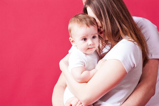 Young mother cuddles her baby