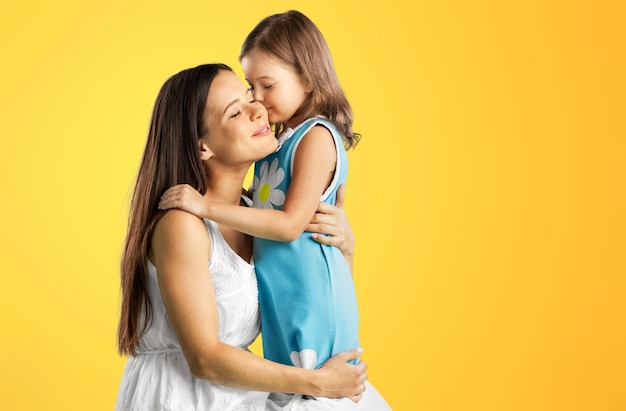 A young mother and a cute child daughter hugging