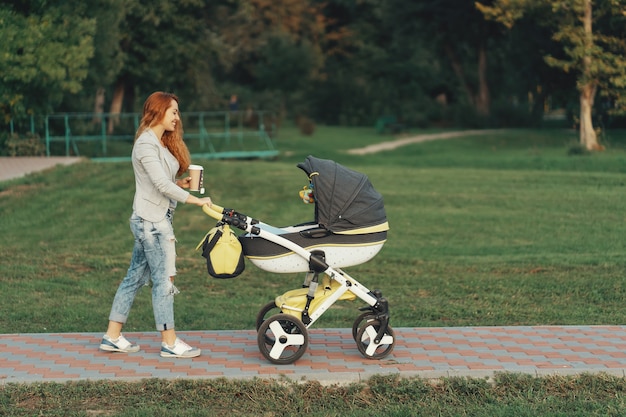 young mother enjoying walk in park with baby