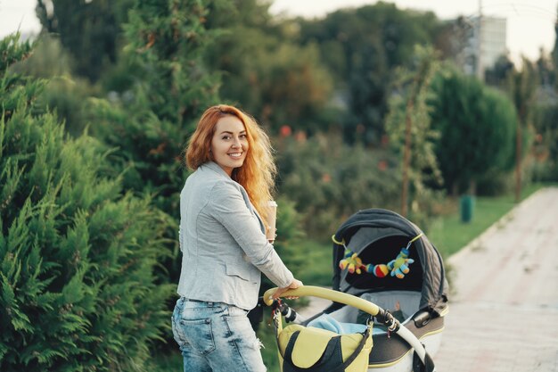 young mother enjoying walk in park with baby