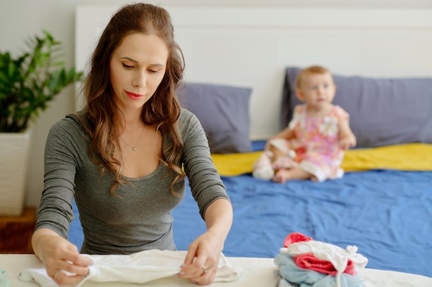 Young Mother Folding Clothes