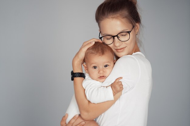 Young mother have fun with her baby at home