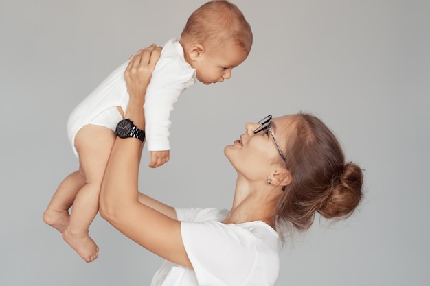 Young mother have fun with her baby at home