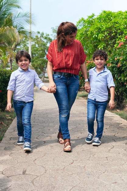 A young mother and her children in a park