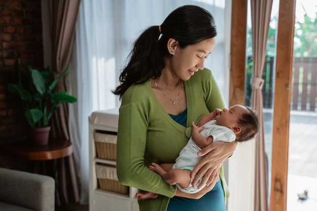 Young mother holding adorable little daughter