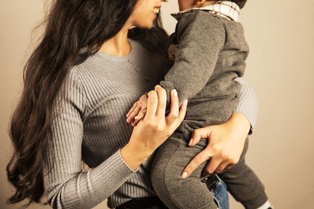 Young mother holding her son in her arms