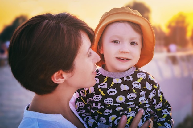 Young mother holds her cute baby in her arms