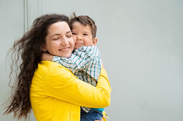 Young mother hugs the baby in her arms.