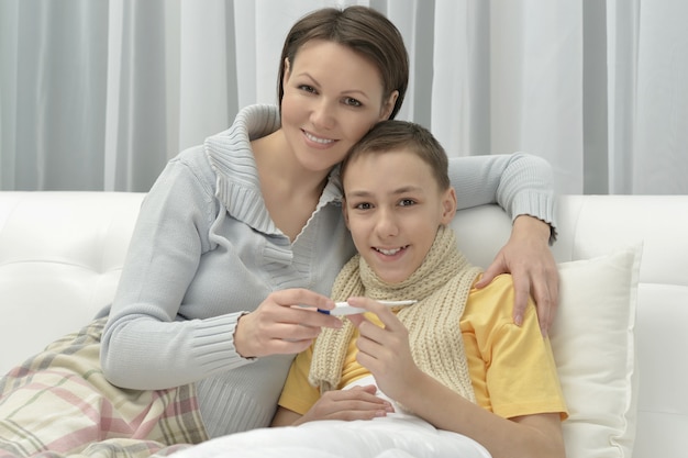 Young mother and ill son in bed