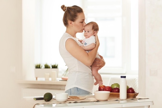 Young mother kissing baby