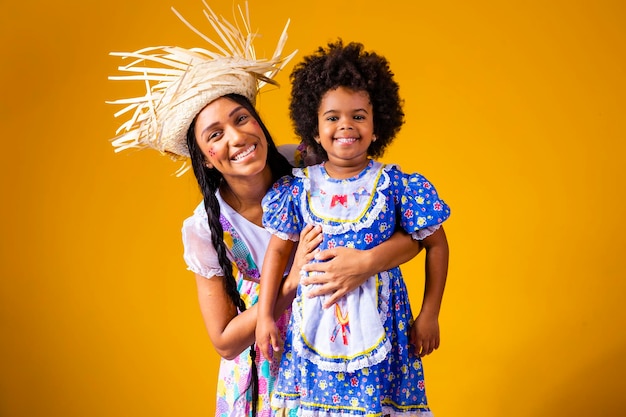 Young mother and little daughter dressed in festa junina outfit for the june party