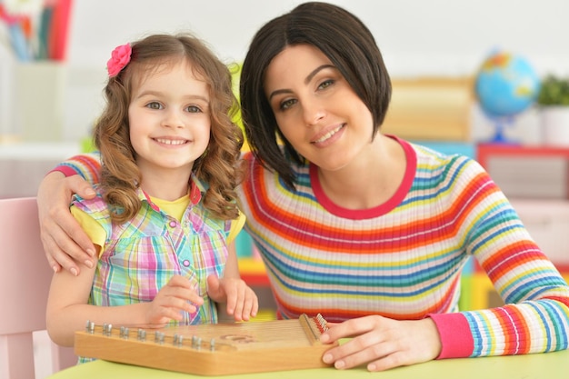 Young mother playing with little daughter