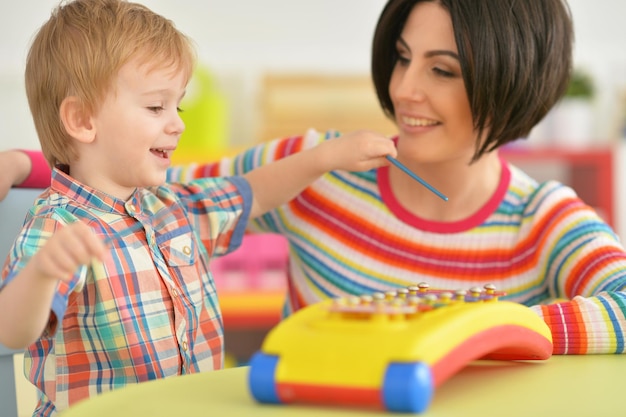 Young mother playing with son