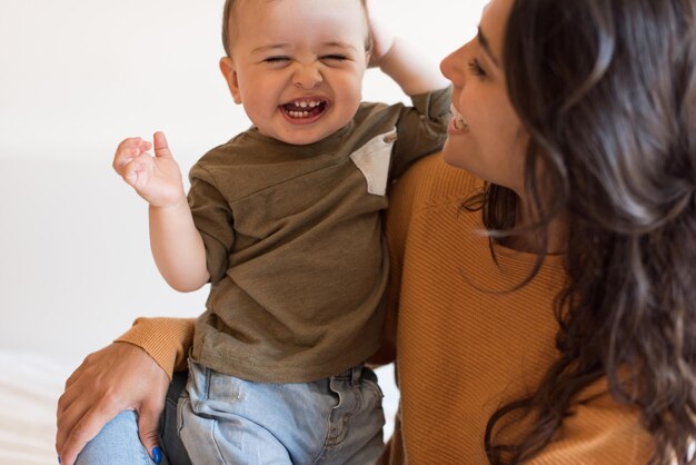 Young Mother playing with toddler at home