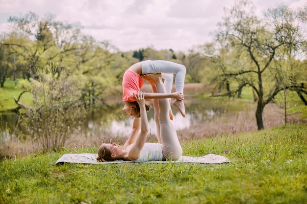 A young mother practices yoga with her daughter.