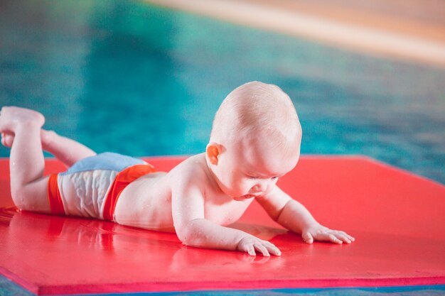 Young mother teaches her child to swim