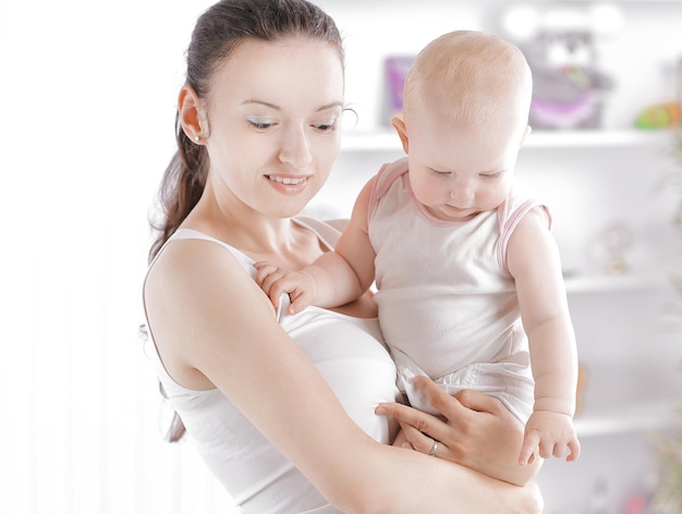 Young mother uses a laptop for freelance work at home