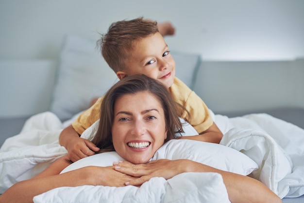 Young mother with 4 years old son in bed