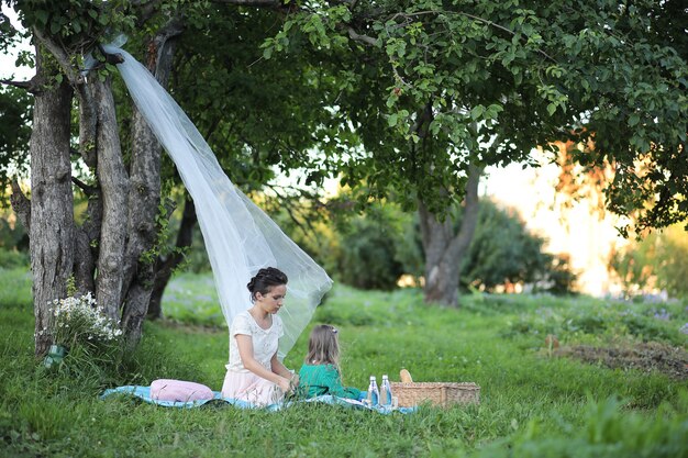 Молодая мать с дочерью на пикнике в парке
