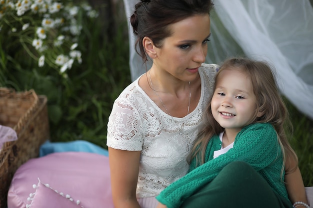 young mother with her daughter at a picnic in the park