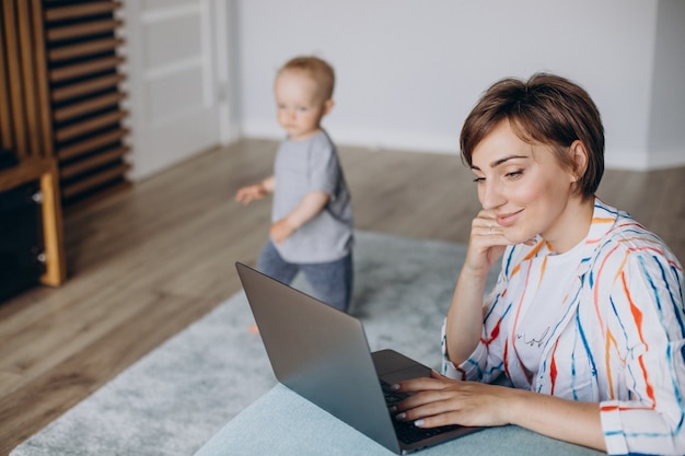 Young mother working on laptop from home