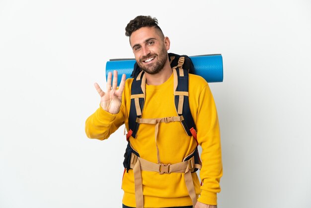 Young mountaineer man with a big backpack over isolated background happy and counting four with fingers