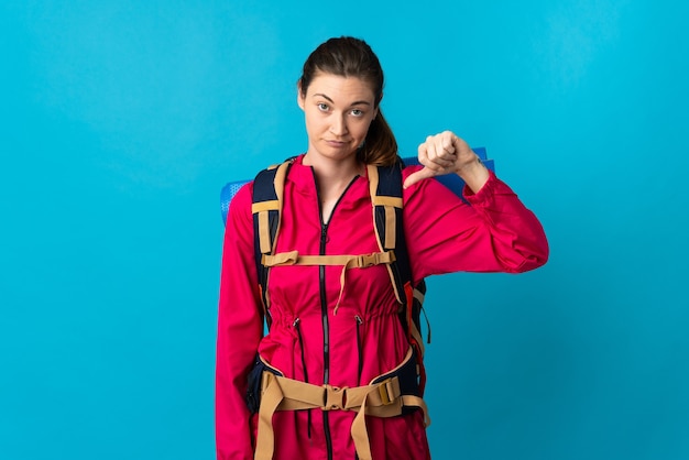 Young mountaineer woman isolated showing thumb down with negative expression