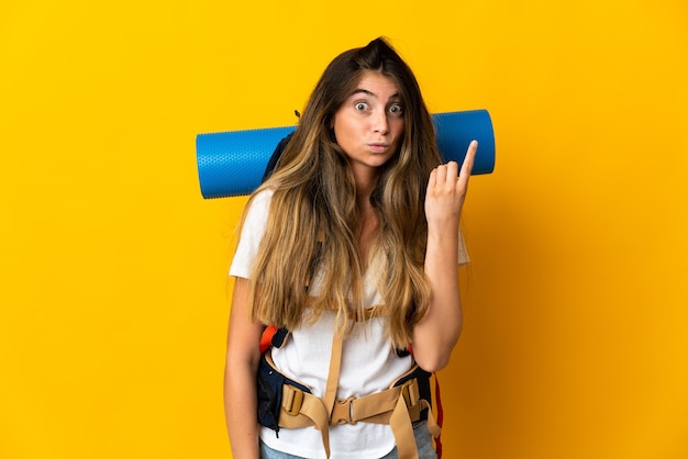 Young mountaineer woman with a big backpack isolated