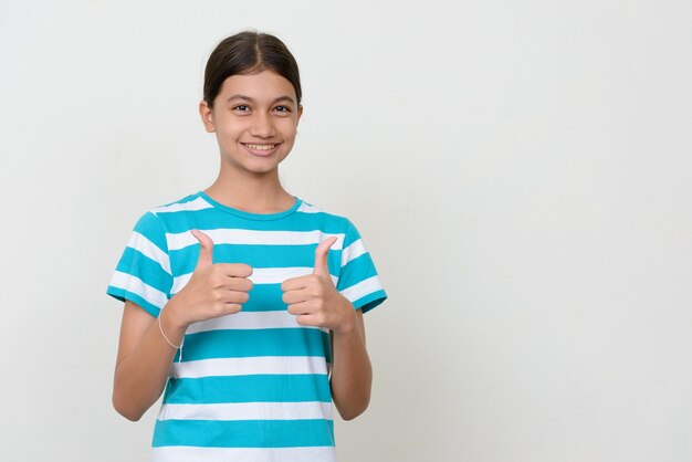 young multi ethnic Asian teenage girl against white wall