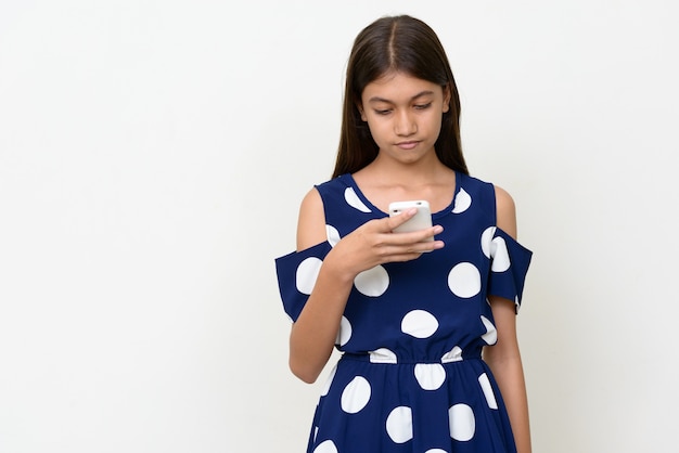 Photo young multi ethnic asian teenage girl against white wall