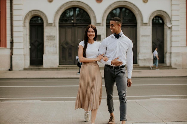 Young multiethnic couple walking on the street